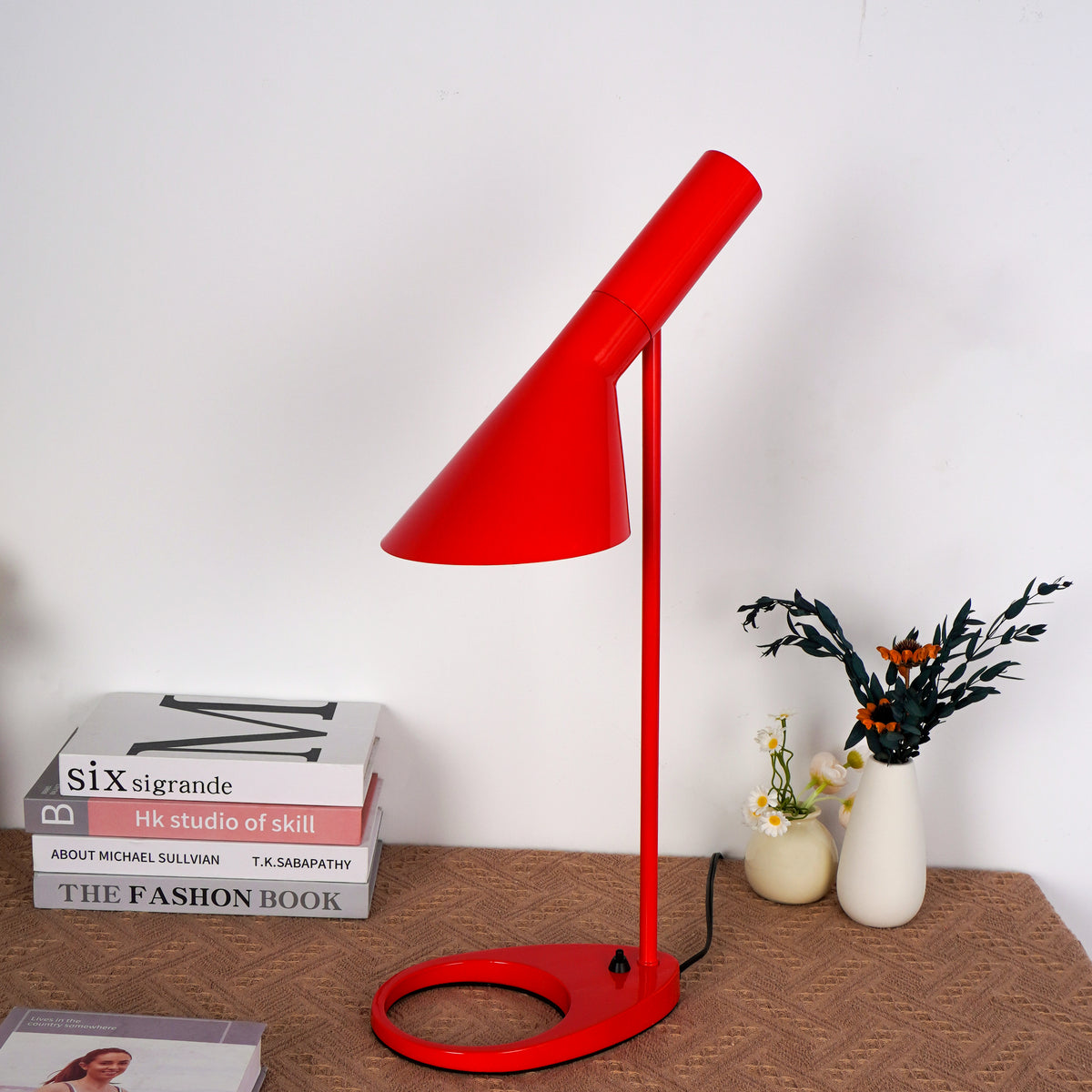 Contemporary crimson table lamp with brushed metal base on marble side table