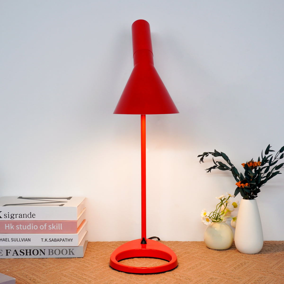 Warm red fabric shade diffusing ambient light in modern living room setting