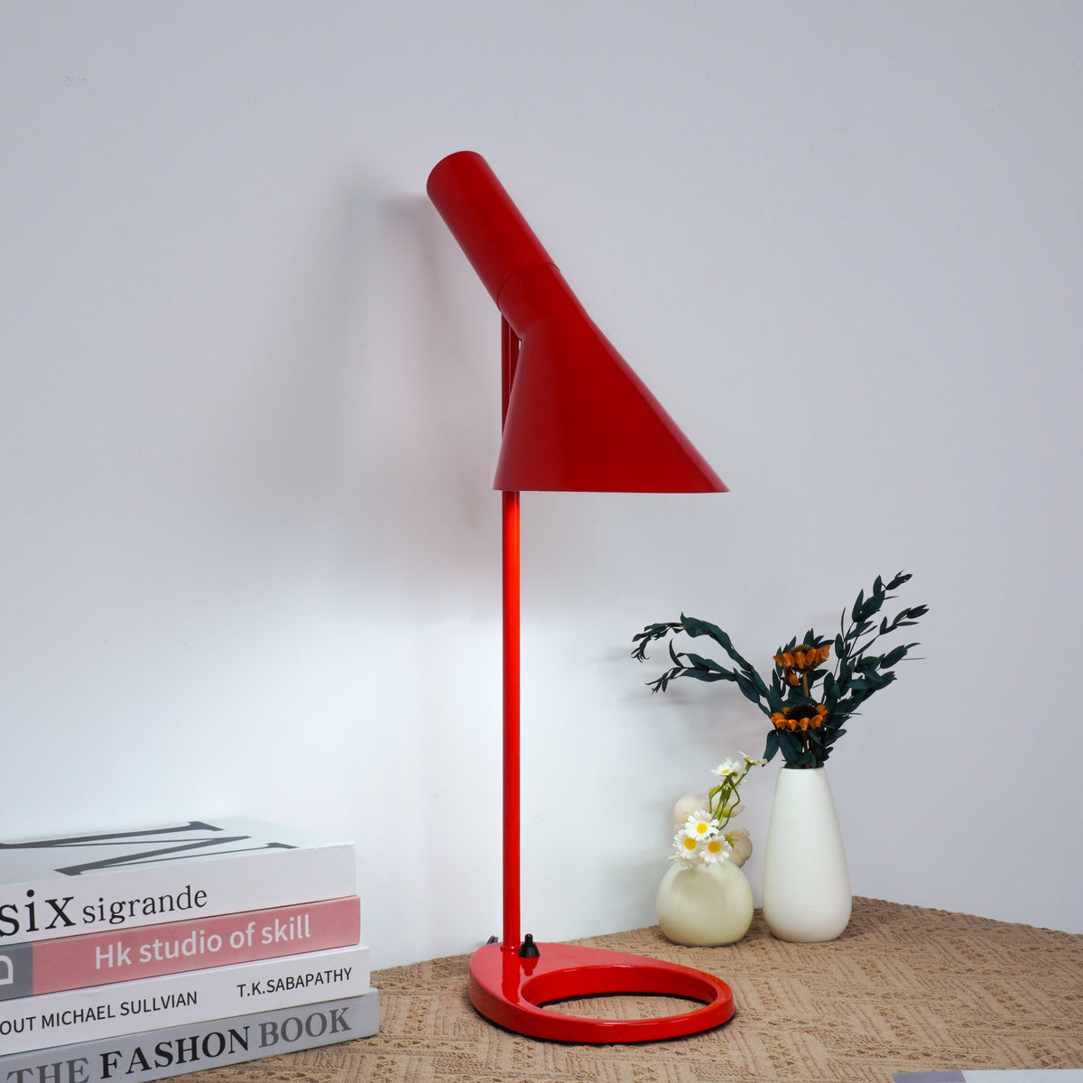 Adjustable arm mechanism demonstration with red lamp over workstation