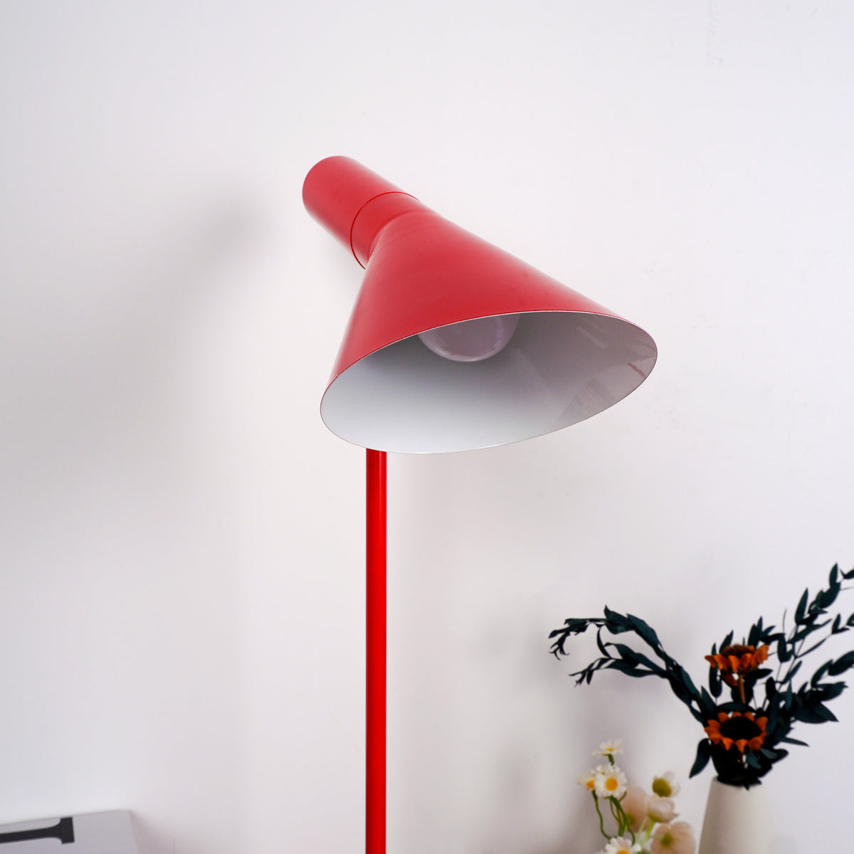 Evening reading setup with red lamp illuminating open hardcover book