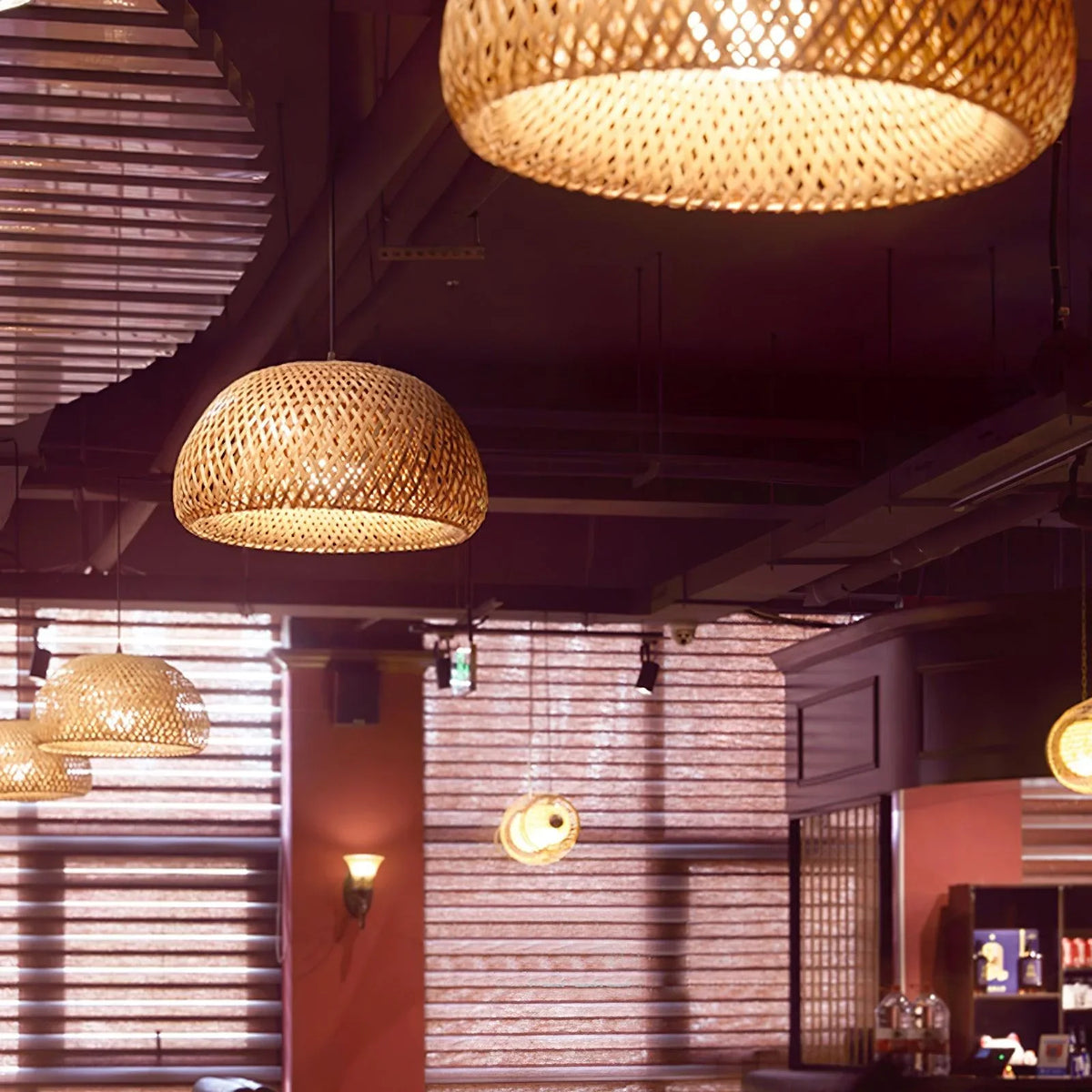 Several Bamboo Basket Pendant Lamps exuding a rustic and natural atmosphere in the cafe.