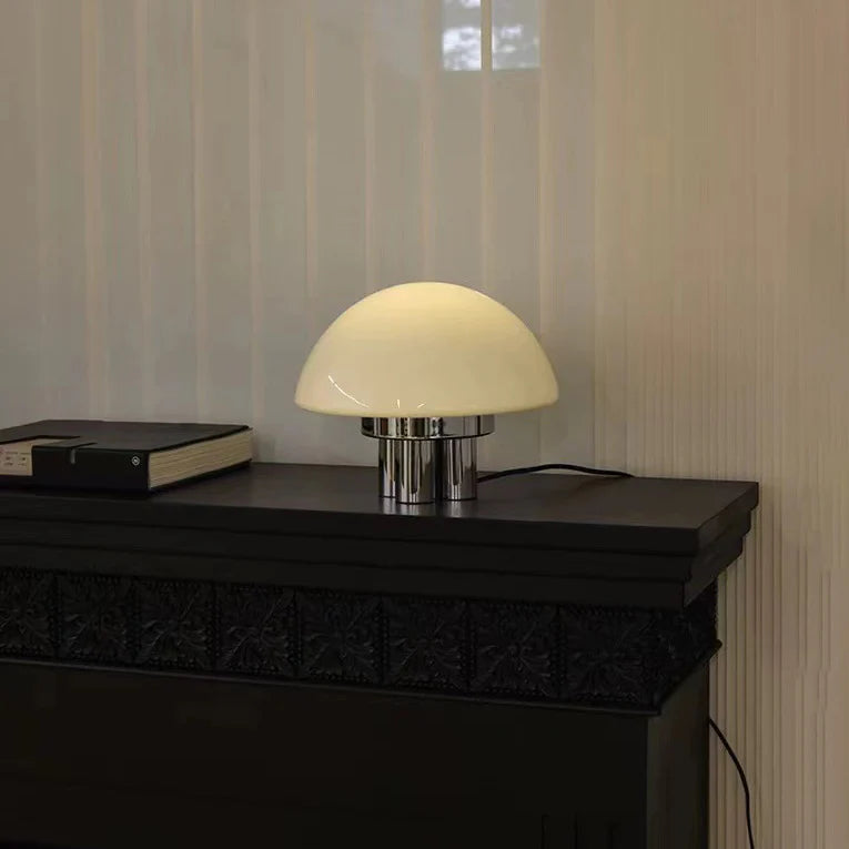 Designed for contemporary spaces, the Bauhaus lamp pairs white glass with a metallic base