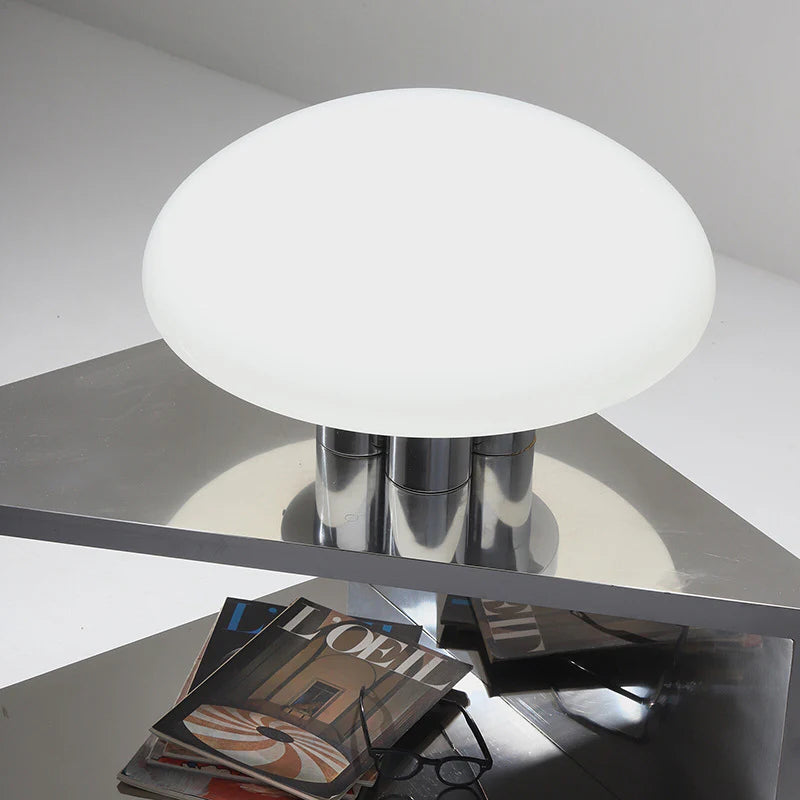 This Bauhaus lamp uses white glass and metallic elements, adding artistic simplicity to rooms.