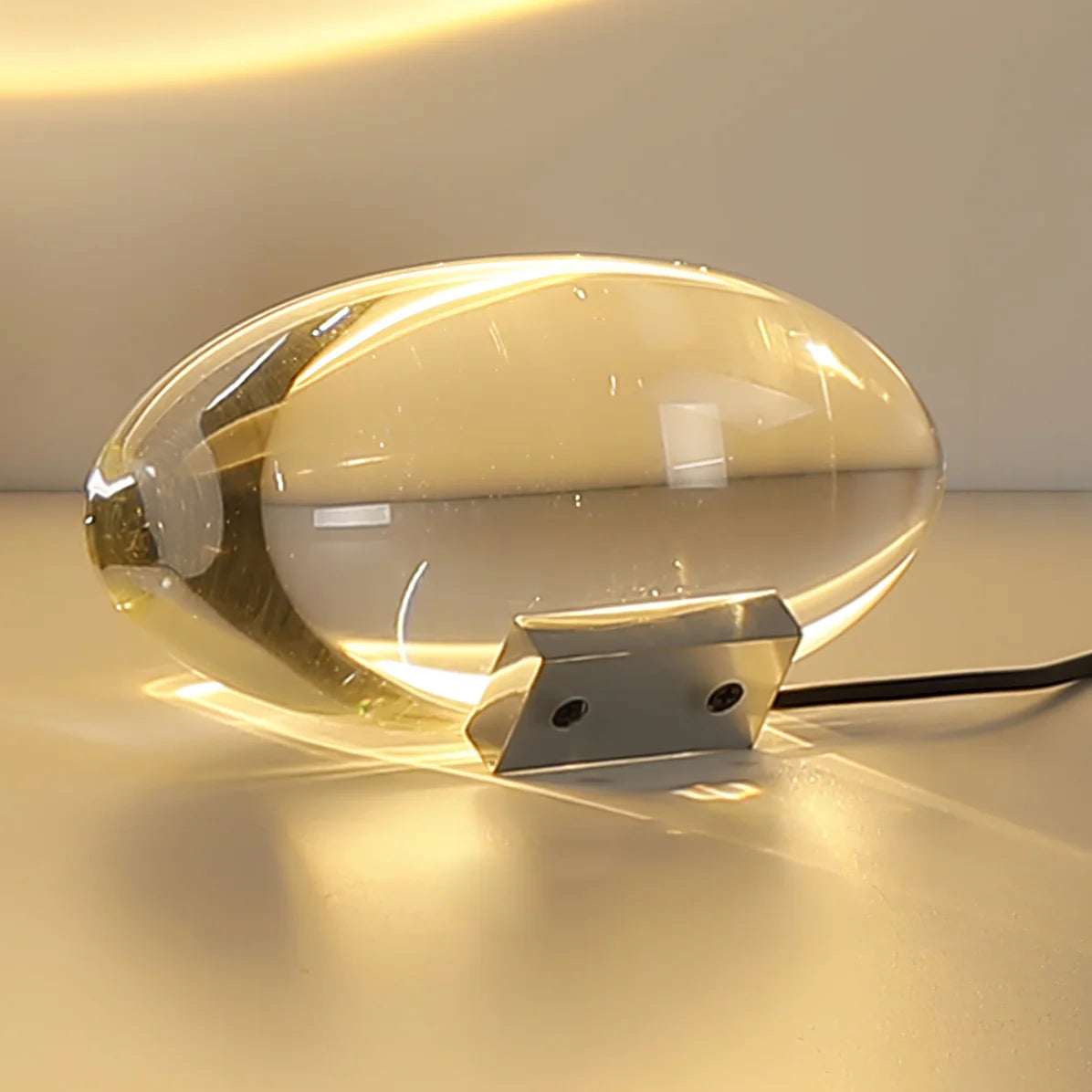 Sleek bullet-shaped desk lamp projects light uniquely, blending modern design.