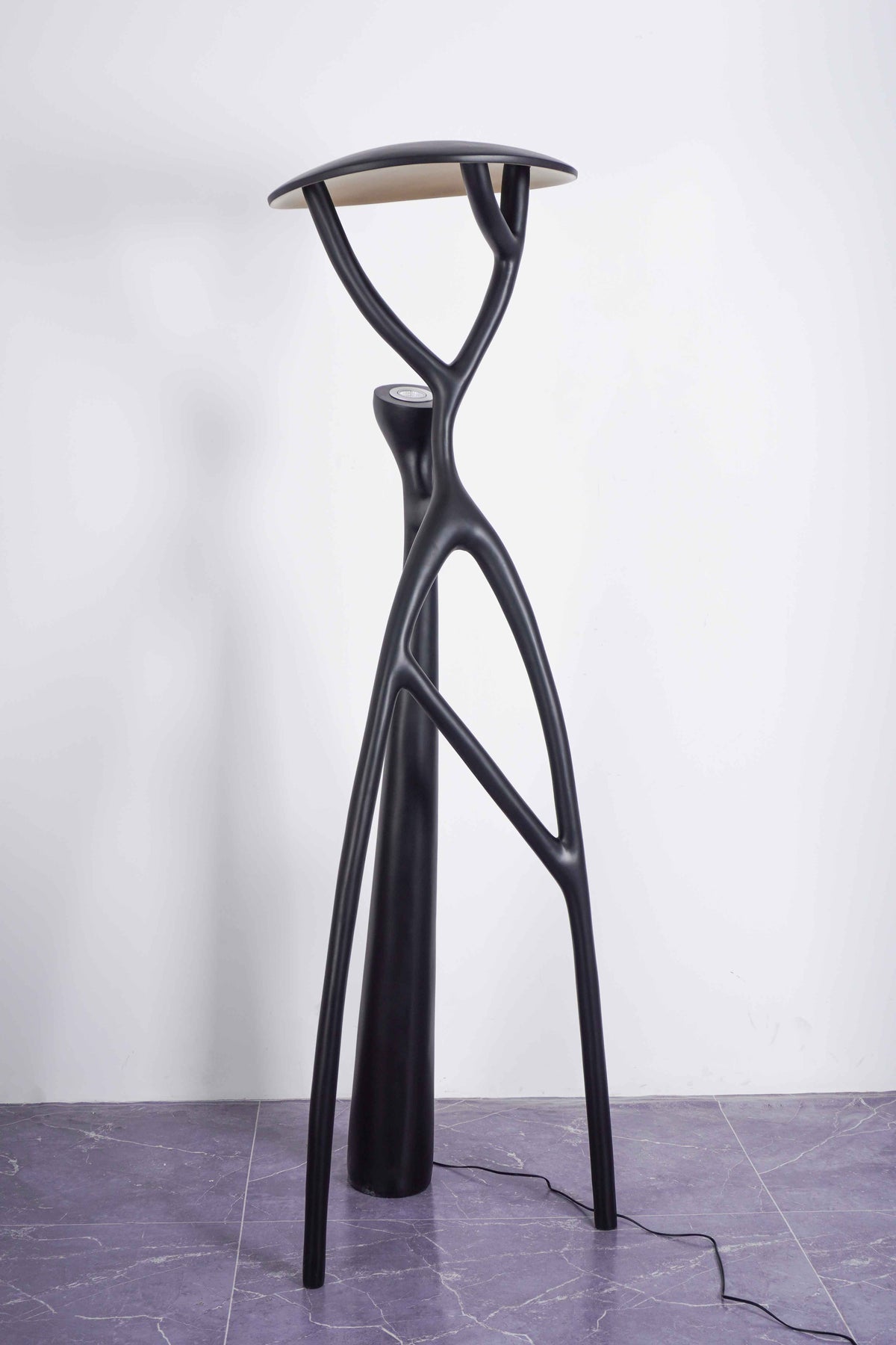 Trendy Floor Lamp: Black branch design ideal for modern, artistic home setups.
