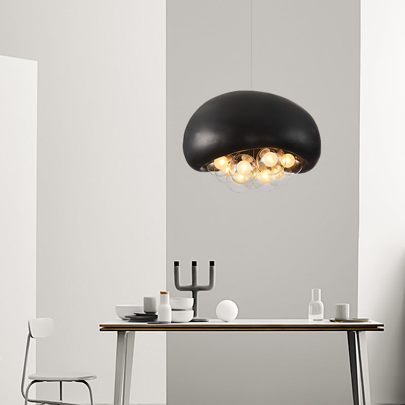 Cement - colored dome lamp with clear bubble - spheres, each with a warm bulb, for contemporary spaces.