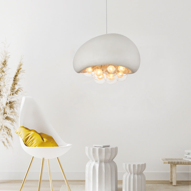 Chic cement pendant, rounded top, transparent bubbles with bulbs, enhancing living/dining areas.