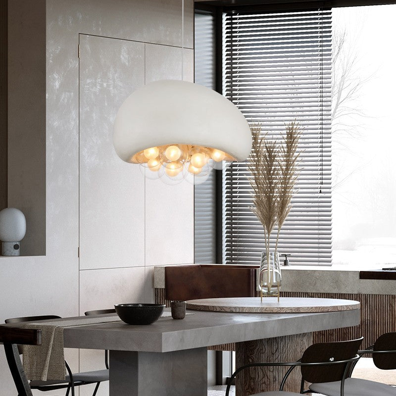 Sleek cement - hued lamp, mushroom - inspired, clear bubbles with bulbs, ideal for modern decor.