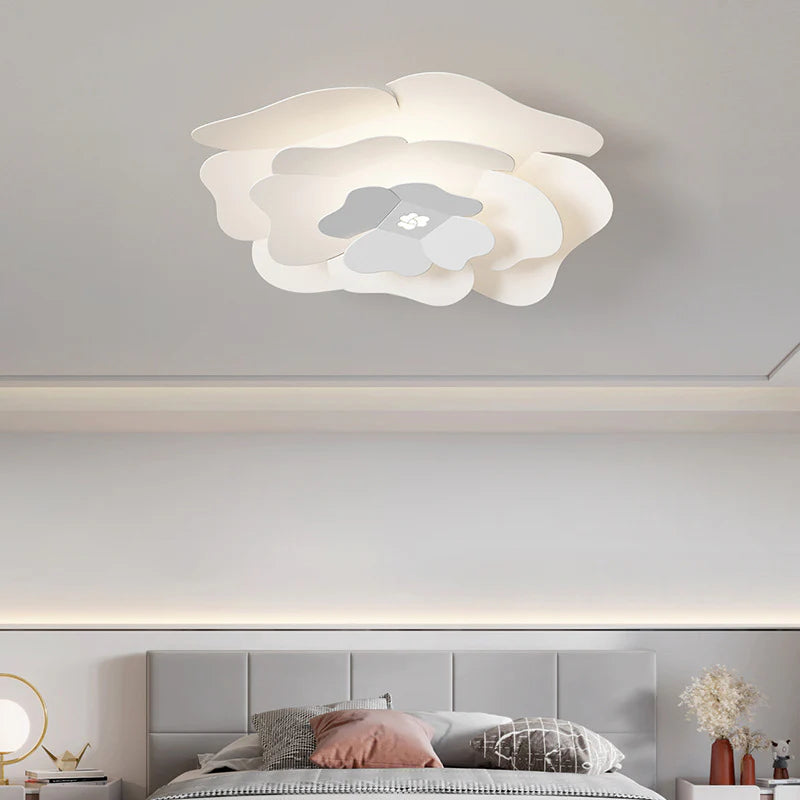 The Creative Personality Lotus Ceiling Lamp is installed on the ceiling of the lounge, and there is a table lamp next to the bed.