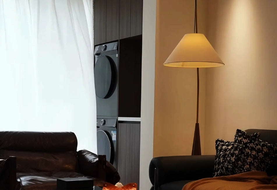 A fishing rod floor lamp illuminates the sofa in the modern living room