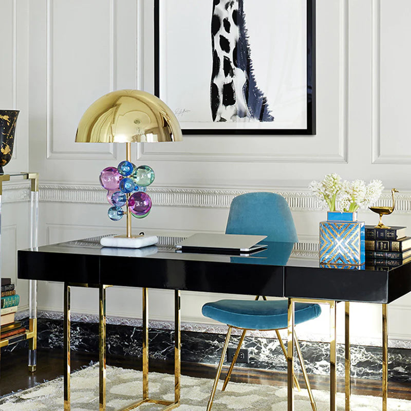 Lustrous golden cover, multicolored glass balls, and a marble foundation suit minimalist reading room.