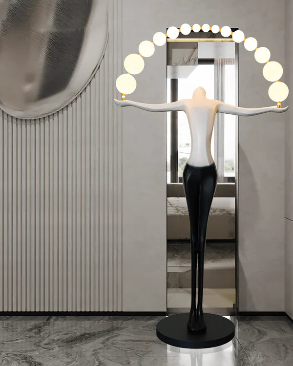 The human-shaped floor lamp is a very suitable artwork for the entrance