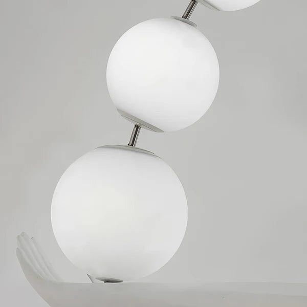 Detail of the white spherical lampshade of the sculptural floor lamp