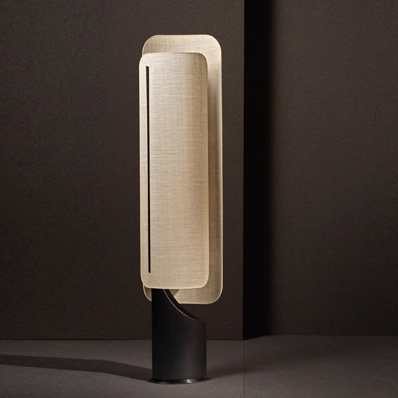 Ibiza Floor Lamp: Merges a metal structure with a cloth cover, blending texture and design seamlessly.