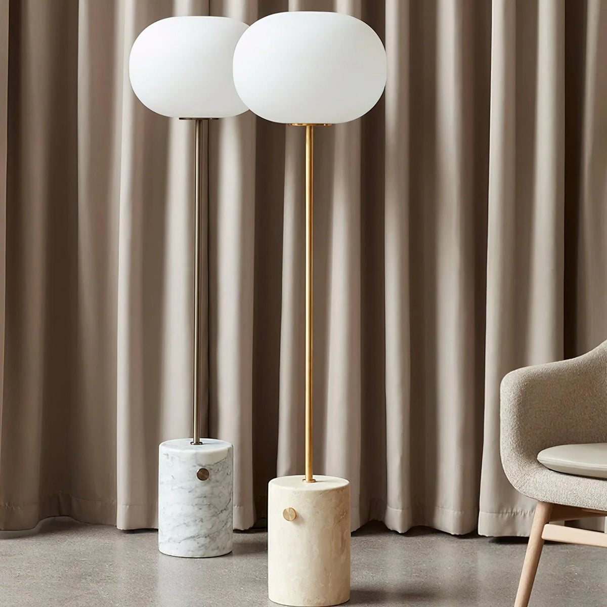 Two modern and simple Jwda Glass Floor Lamps are placed one in front of the other next to the table and chairs