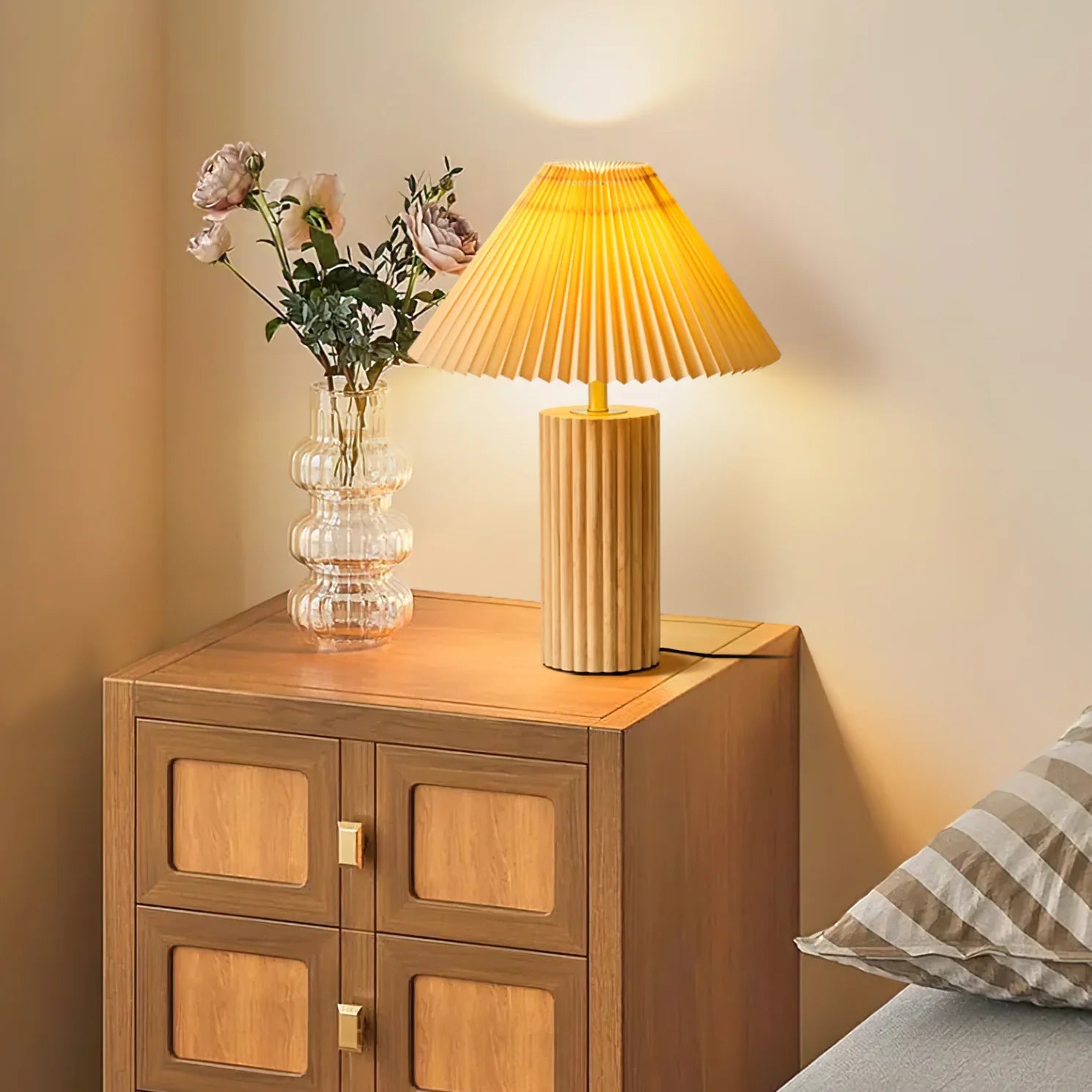 Japanese-style Kimaki Table Lamp emits warm light on the wooden cabinet next to the bed
