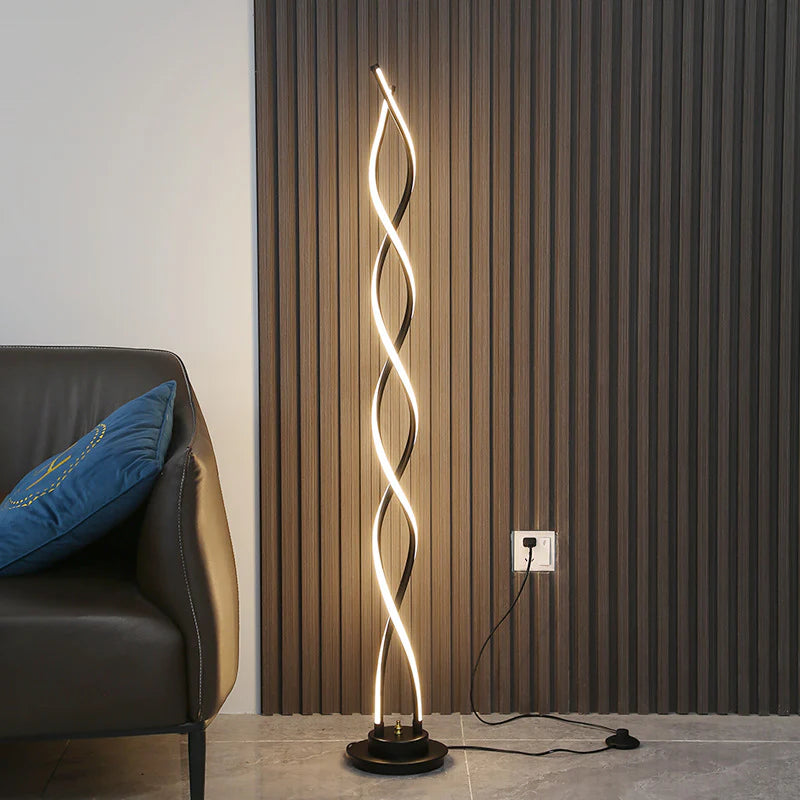 Soft ambient light from black spiral lamp in dark-themed interior.