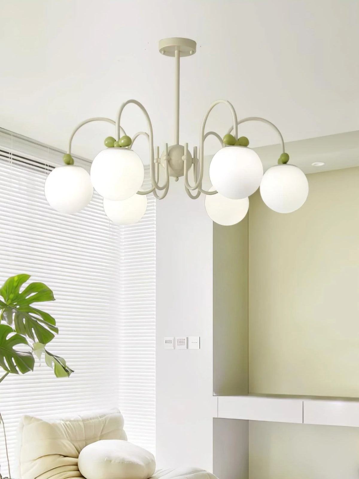 Adorable lighting: white spheres with cherry details elevate room’s modern charm.
