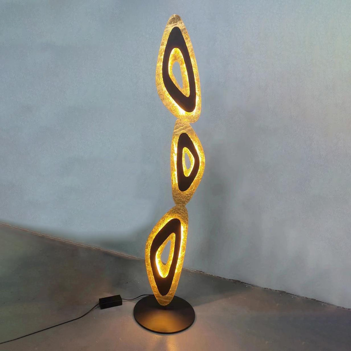 Unique lamp combines flowing forms, casting soft light in living areas.