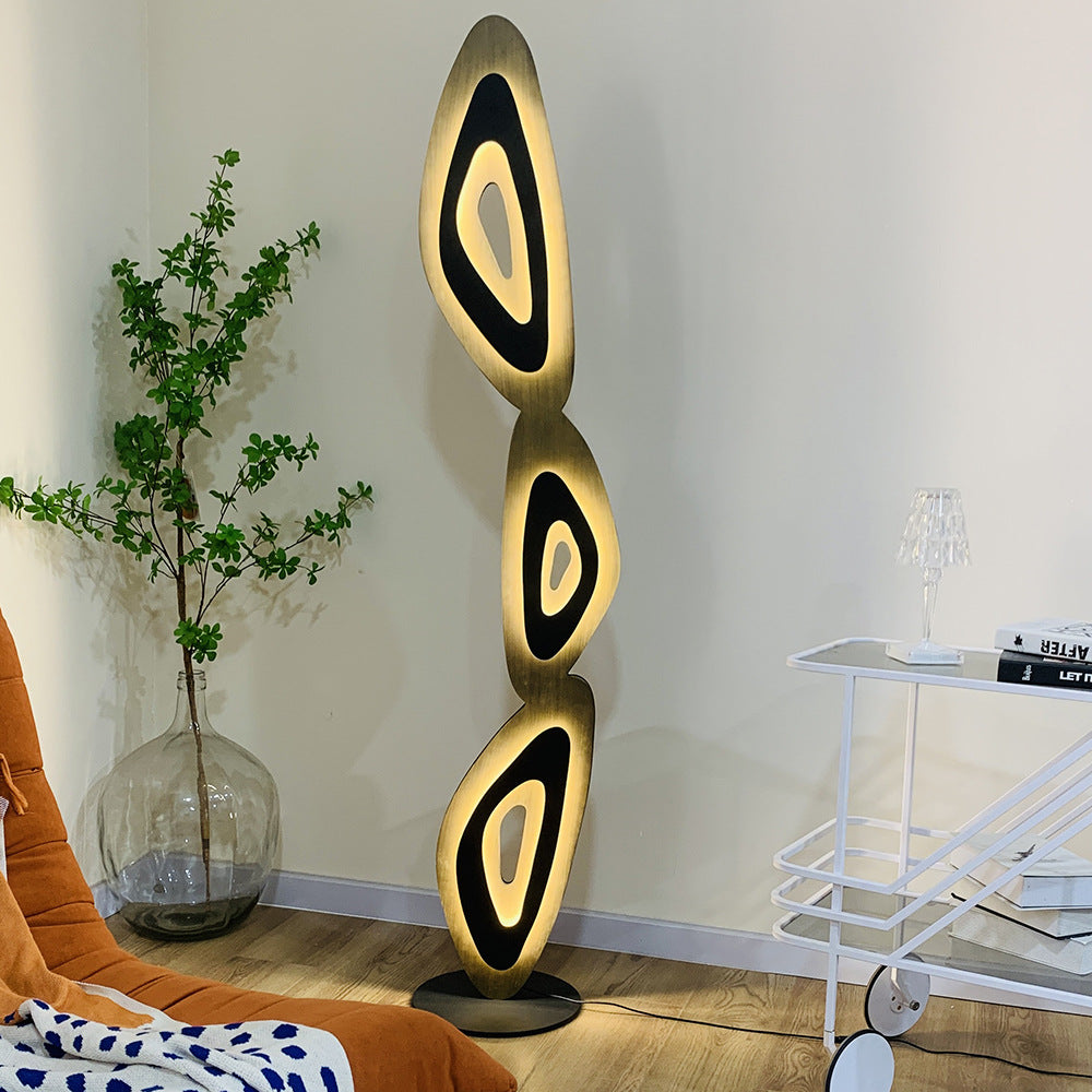 Modern floor lamp enhances rooms with its artistic, tiered structure.