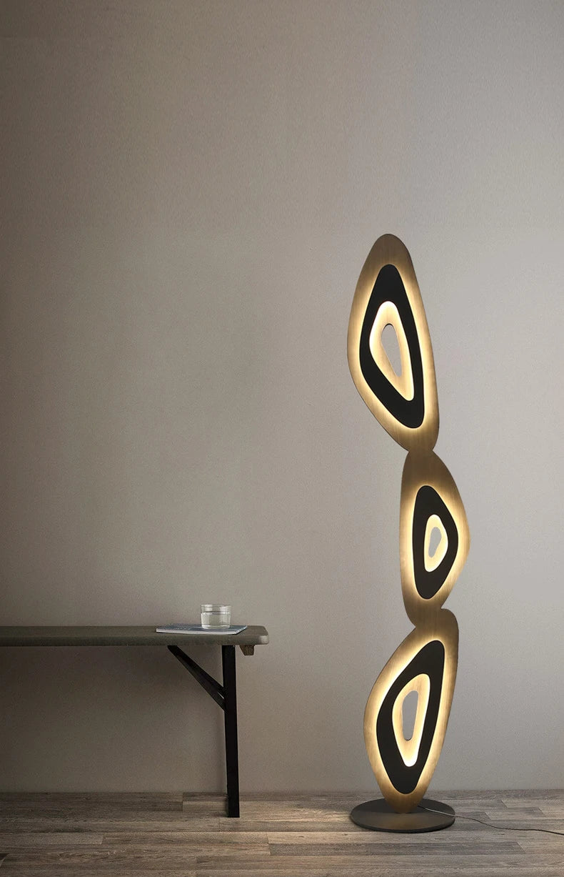 Artistic floor lamp creates visual interest while providing warm lighting.