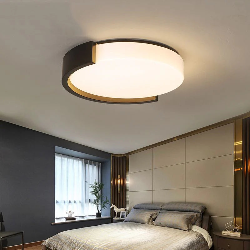 This creative round ceiling light boasts a sleek design, casting soft light to elevate room aesthetics with modern charm.