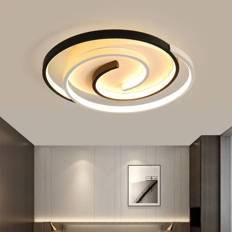 Modern spiral ceiling light with layered circular strips, merging artistic design and soft illumination.