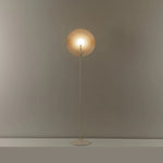 Minimalist floor lamp uses a slim pole to connect the circular shade, outlining unique beauty with simple lines.