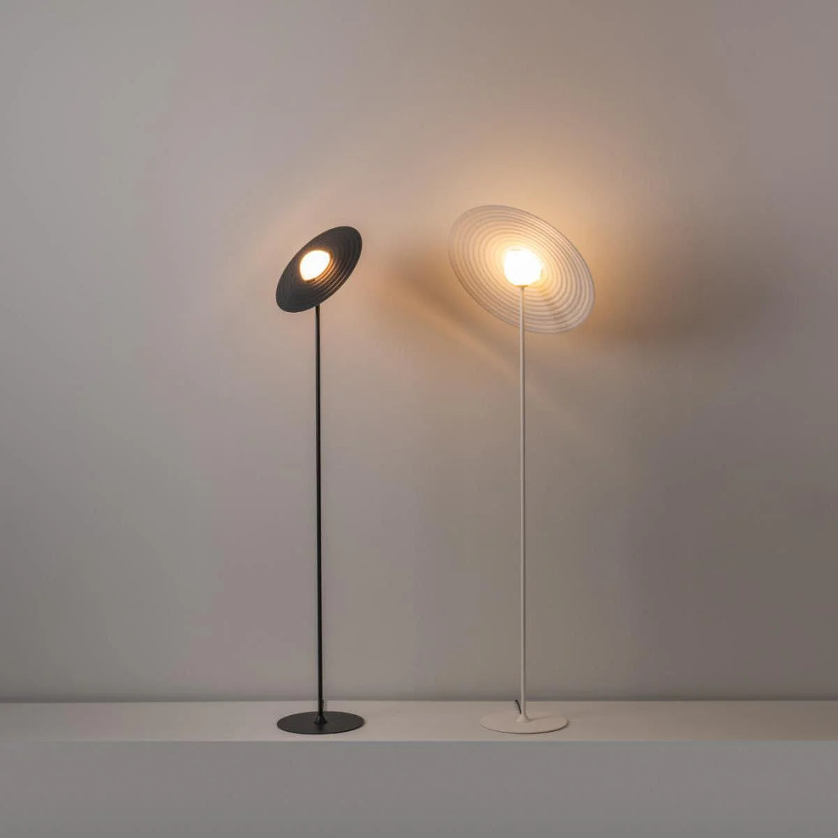 Modern floor lamp blends record-inspired design with minimalist metal structure, quietly elevating room style.
