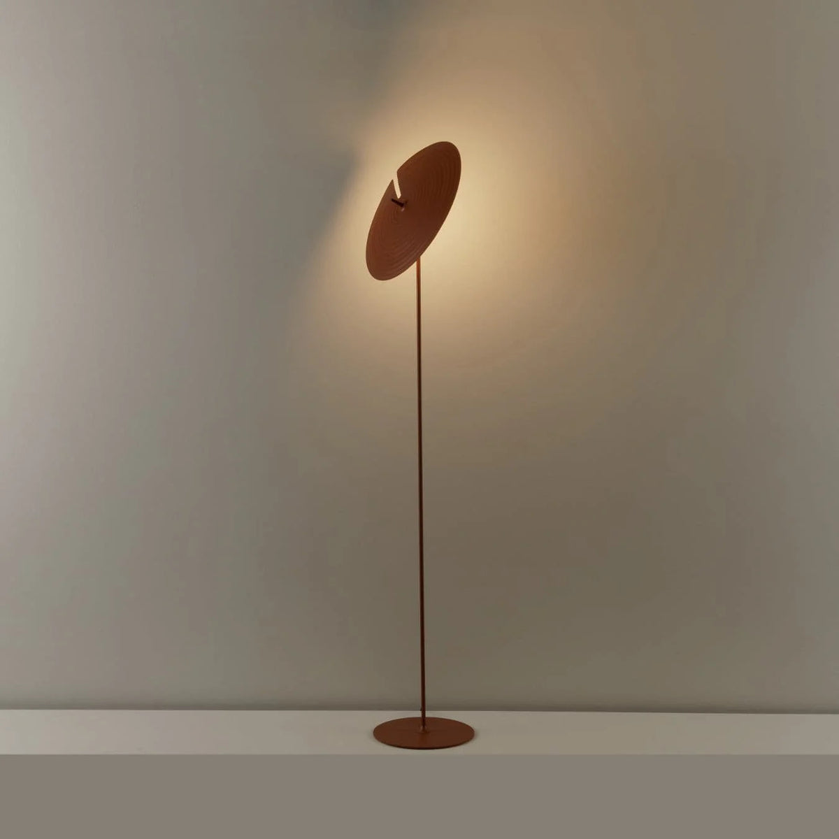 floor lamp showcases industrial style and artistry, with a record shade and slim pole full of design sense.