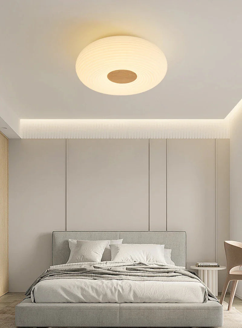 Functional round ceiling light suits bedroom’s design style.