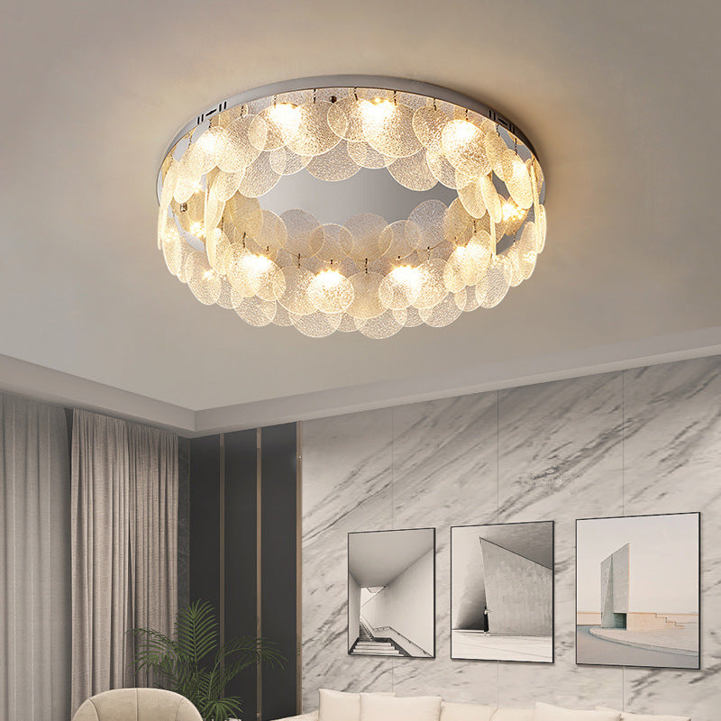The light luxury living room is hung with a ceiling lamp made of glass discs