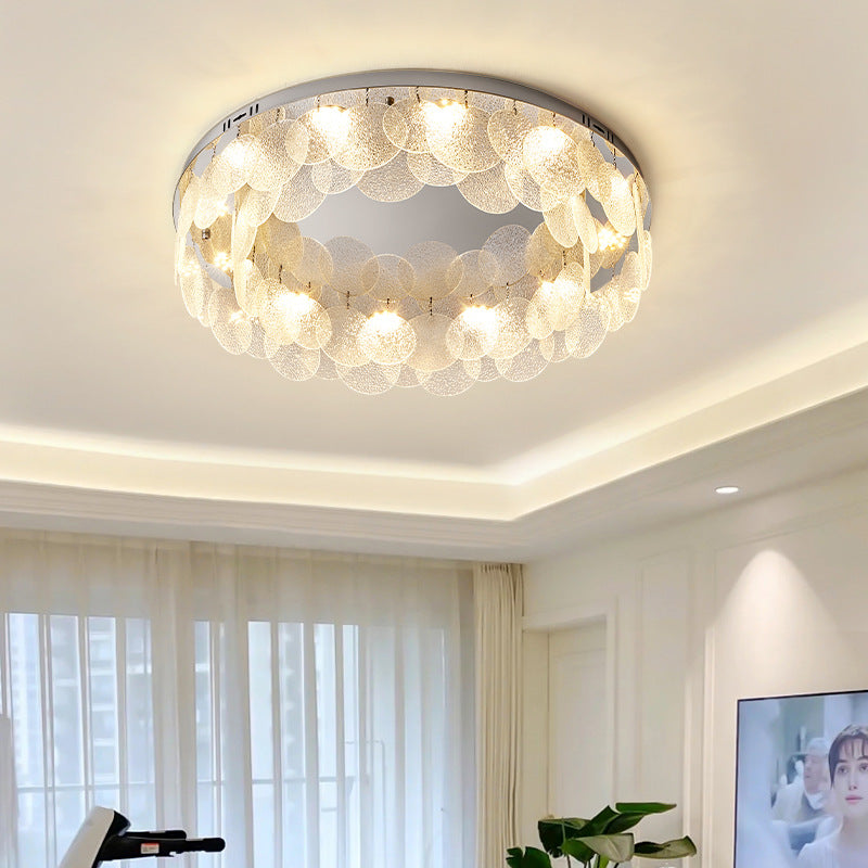 The ceiling light made of glass round pieces in a staggered arrangement is in the living room.