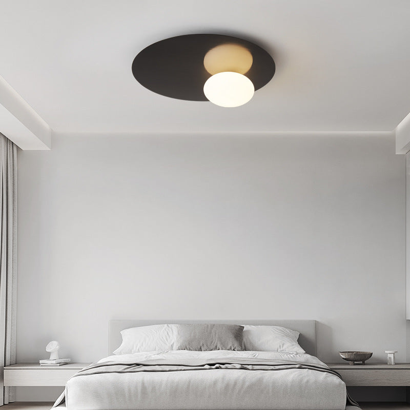 The black style elliptical ceiling lamp in the simple bedroom.