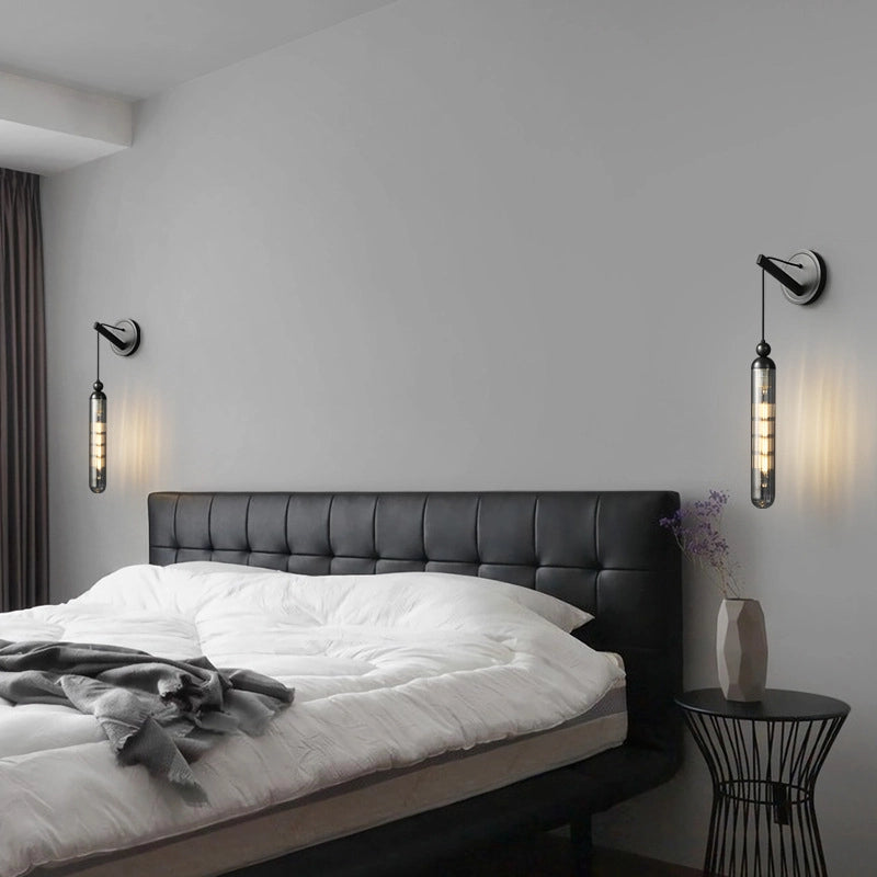 The black leather head board is matched with white bedding_and a gray blanket is draped in one corner.Simple wall lamps are installed symmetrically on both side softhebed_with soft warmlight