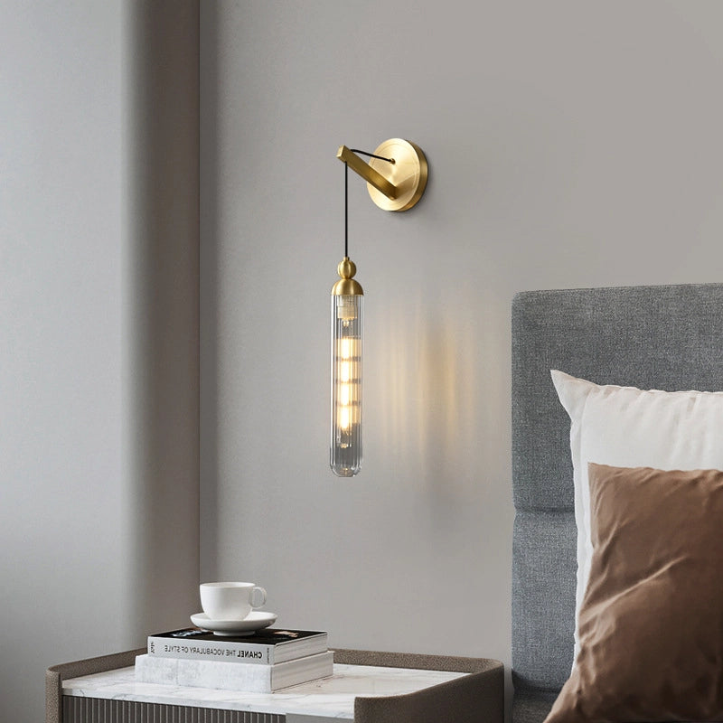 The gold base and the transparent lamp tube are exquisitely matched.Books are stacked on the bedside table_and white cups and saucers are placed on them
