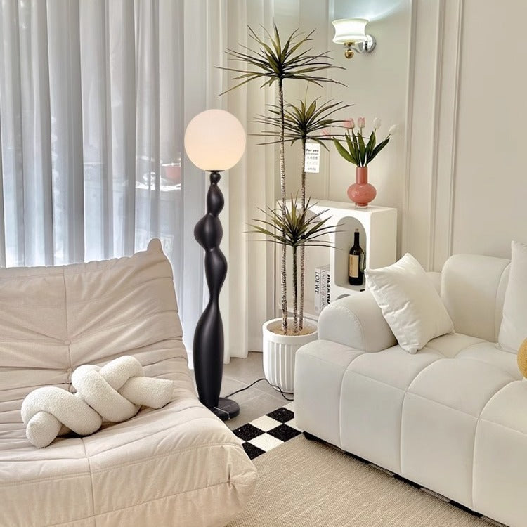 Very Sense Floor Lamp in the corner of the cream style living room