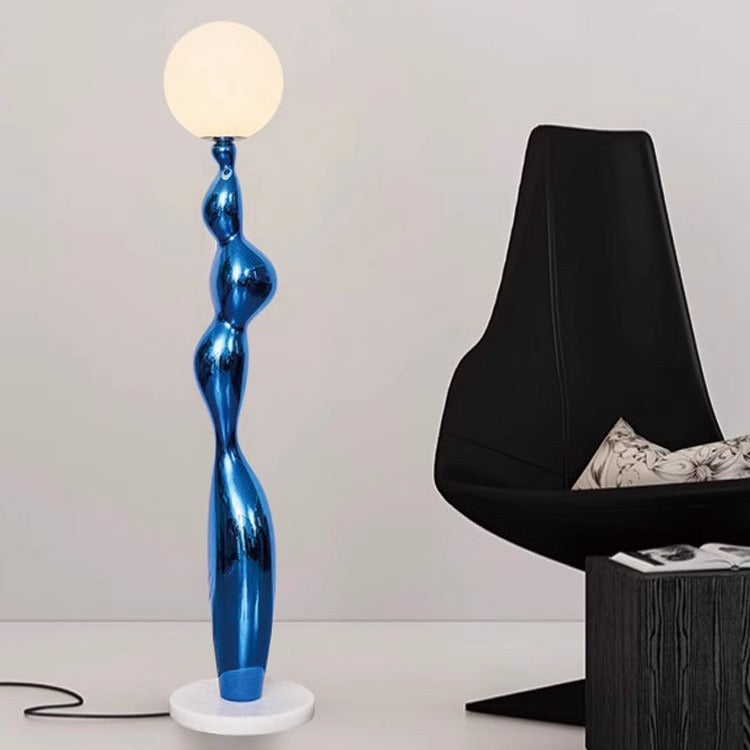 A blue lamp post floor lamp with a high sense of design is next to the office chair