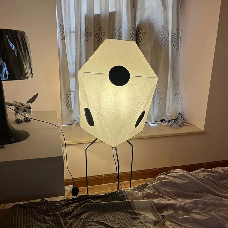 Crafted from rice paper, this Japanese-style lamp features a unique geometric form with black accents