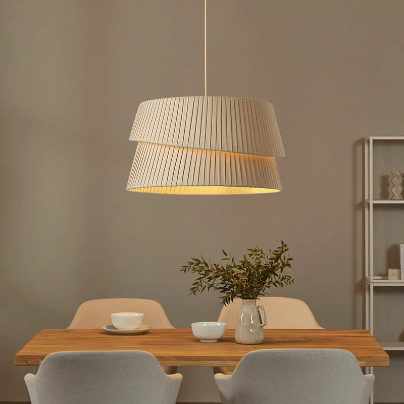 In the restaurant, the chandelier with a light beige fabric lampshade falls elegantly, and the double-layer pleated texture design is simple and chic.