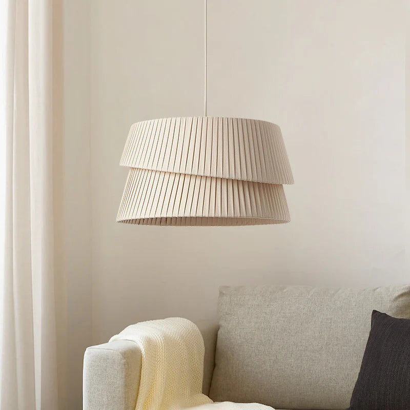 Indoors, a double-layer pleated-textured chandelier hangs above the sofa, creating a warm atmosphere.
