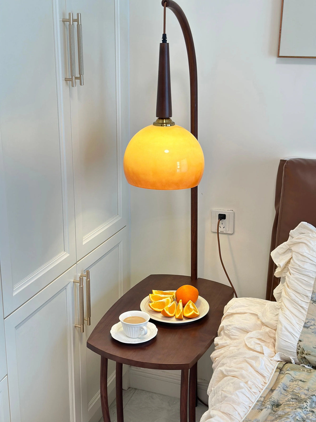 Elegant living-space decor: floor lamp showcasing grapefruit-form glass shade and storage shelf