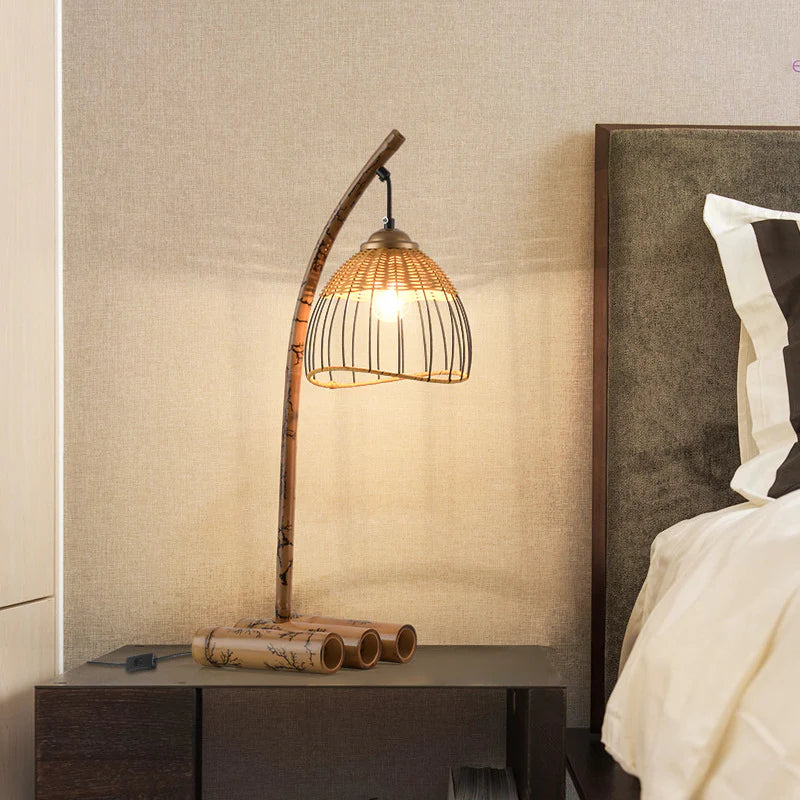 In the bedroom, there is a bamboo table lamp on the bedside table, with a curved lamp pole and a rattan lampshade.