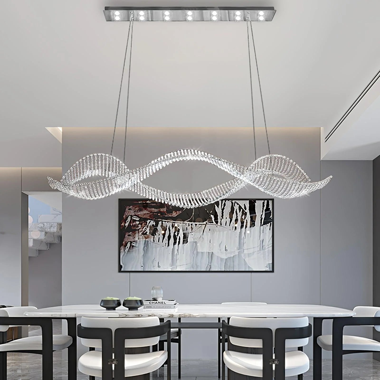 The horizontal double helix chandelier hangs above the marble table