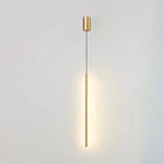Single brushed brass cylinder pendant lamp illuminated against white background