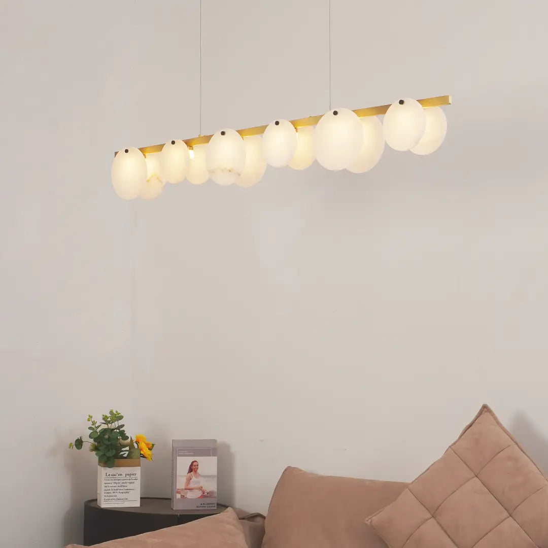 Lit alabaster restaurant chandelier emits soft warm light to beautify spacious living room space