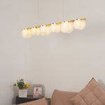 Lit alabaster restaurant chandelier emits soft warm light to beautify spacious living room space