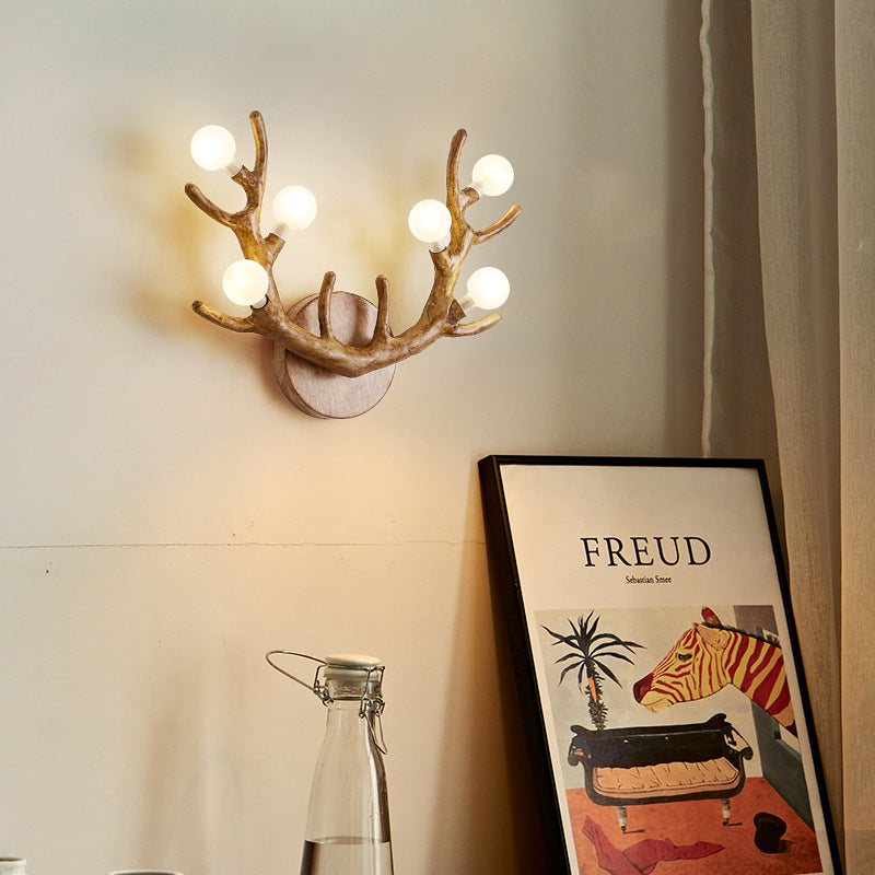 Antler Branch Wall Lamp in earthy brown resin, mimicking natural deer antlers for rustic wall decor.