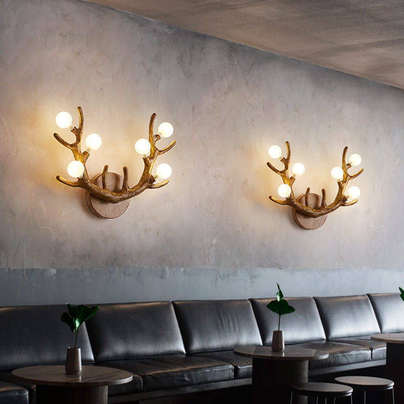 Antler Branch Wall Lamp’s adjustable brackets for flexible positioning on textured stone walls.