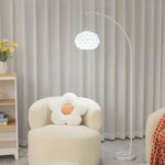 There is a pine cone lampshade floor lamp made of acrylic in the room